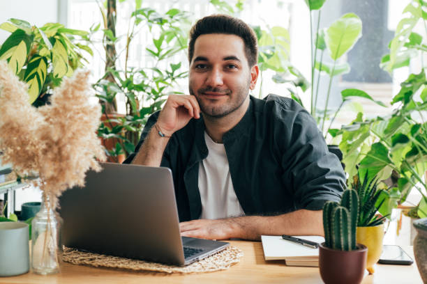 A well-lit office with a desk plant setup, featuring easy-care air-purifying plants